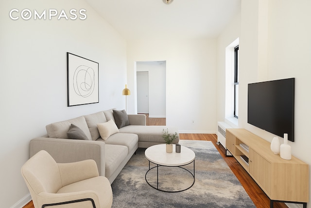 506 W 145th St Unit 4D, New York City, NY 10031 - living area featuring radiator and dark wood-style flooring