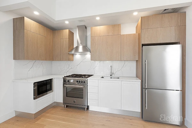 10-64 Jackson Ave Unit 4B, New York City, NY 11101 - kitchen featuring stainless steel appliances, wall chimney range hood, light wood-style flooring, decorative backsplash, and recessed lighting