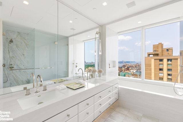200 Amsterdam Ave Unit 32B, New York City, NY 10023 - bathroom featuring double vanity, healthy amount of natural light, a bath, and a marble finish shower