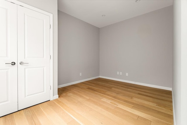 20 W St Unit 18F, New York City, NY 10004 - unfurnished bedroom with baseboards and light wood-type flooring