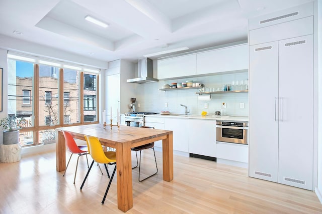 210 Jackson St Unit 2, New York City, NY 11211 - kitchen with wall chimney range hood, stainless steel appliances, open shelves, and light wood-type flooring