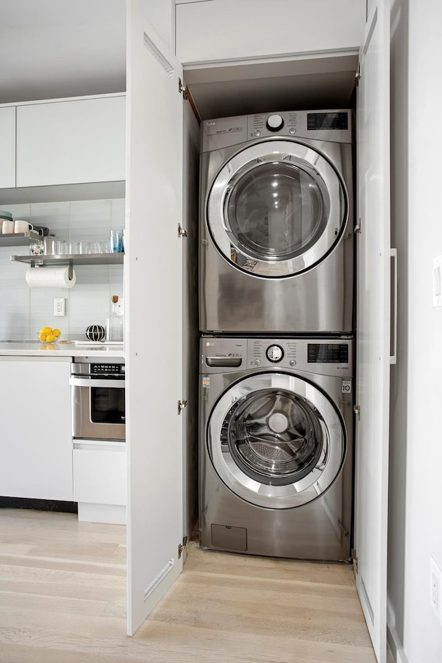 210 Jackson St Unit 2, New York City, NY 11211 - washroom with stacked washer / dryer and light wood-style floors