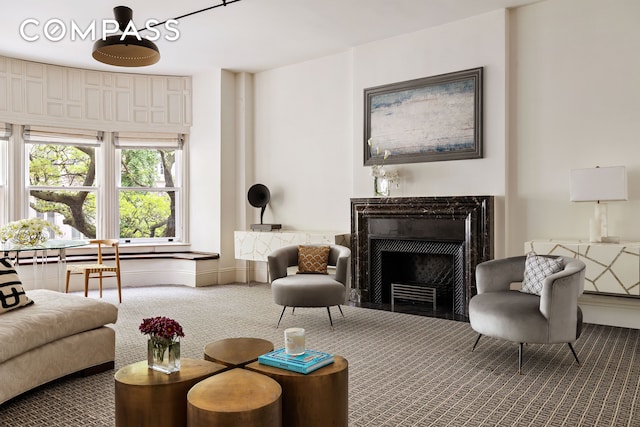 4 E 82nd St Unit 3F, New York City, NY 10028 - carpeted living area featuring a fireplace and baseboards