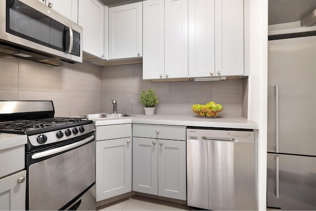 330 E 33rd St Unit 8F, New York City, NY 10016 - kitchen with stainless steel appliances, tasteful backsplash, light countertops, and white cabinets