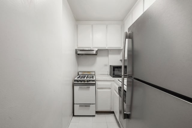 7 E 14th St Unit 923, New York City, NY 10003 - kitchen featuring freestanding refrigerator, white gas range, under cabinet range hood, white cabinets, and light tile patterned flooring