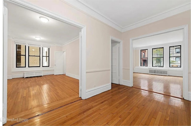 118 W 79th St Unit 9B, New York City, NY 10024 - empty room featuring light wood-type flooring, ornamental molding, and radiator