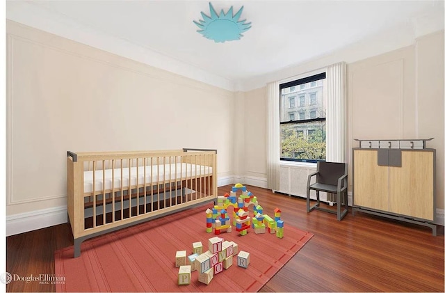118 W 79th St Unit 9B, New York City, NY 10024 - bedroom with wood finished floors and a crib