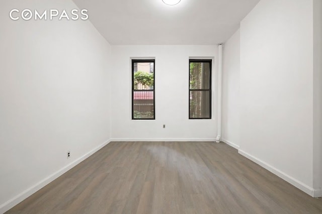 312 W 49th St Unit 1Rw, New York City, NY 10019 - spare room featuring wood finished floors and baseboards