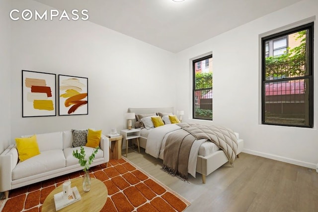 312 W 49th St Unit 1Rw, New York City, NY 10019 - bedroom with wood finished floors and baseboards
