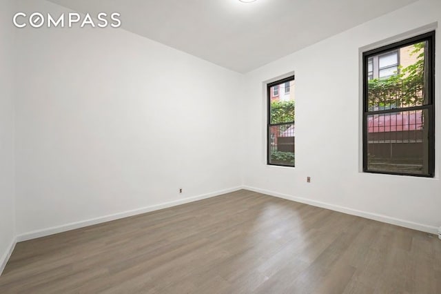 312 W 49th St Unit 1Rw, New York City, NY 10019 - spare room featuring wood finished floors and baseboards