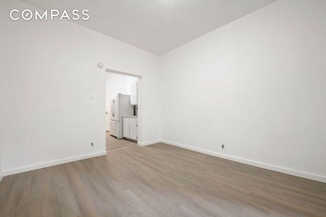 312 W 49th St Unit 1Rw, New York City, NY 10019 - spare room featuring light wood-style flooring and baseboards