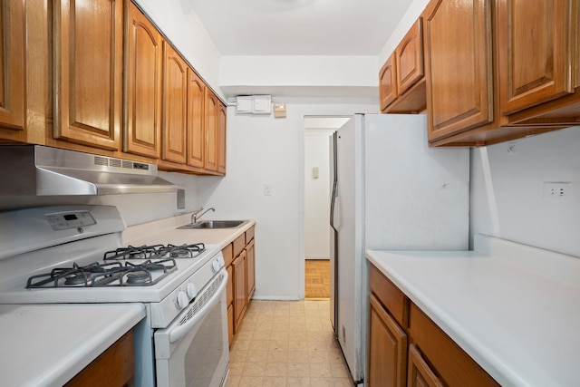 270 Jay St Unit 1D, New York City, NY 11201 - kitchen with white appliances, under cabinet range hood, light floors, brown cabinets, and light countertops