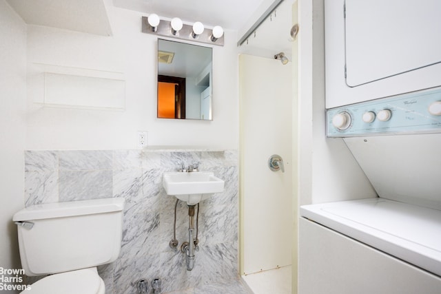 47 King St Unit 2, New York City, NY 10014 - full bath featuring stacked washer and clothes dryer and tile walls