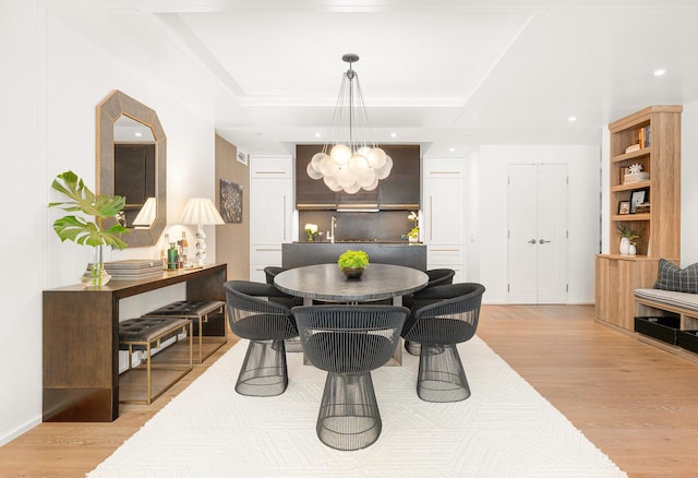 345 W 14th St Unit 5A, New York City, NY 10014 - dining area with light wood-type flooring, a chandelier, recessed lighting, and a raised ceiling