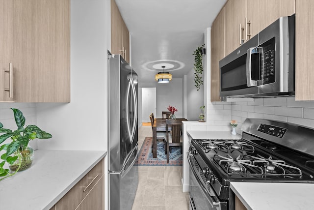 3520 Tryon Ave Unit 603, New York City, NY 10467 - kitchen featuring stainless steel appliances, decorative backsplash, light stone countertops, modern cabinets, and light tile patterned floors