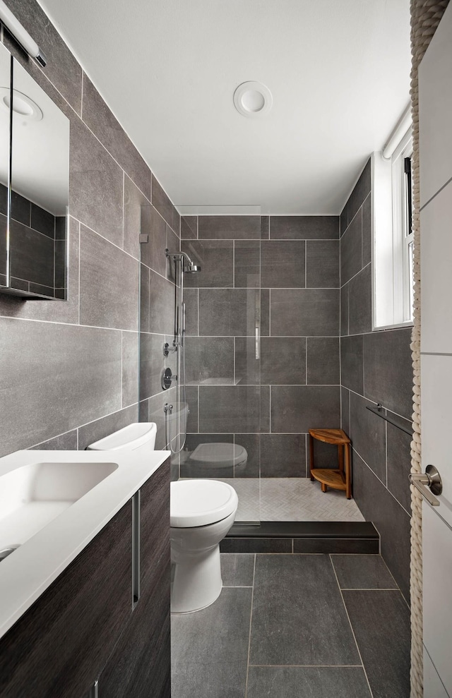 26 Gramercy Park S Unit 8Cd, New York City, NY 10003 - full bath featuring a tile shower, tile walls, vanity, and tile patterned flooring