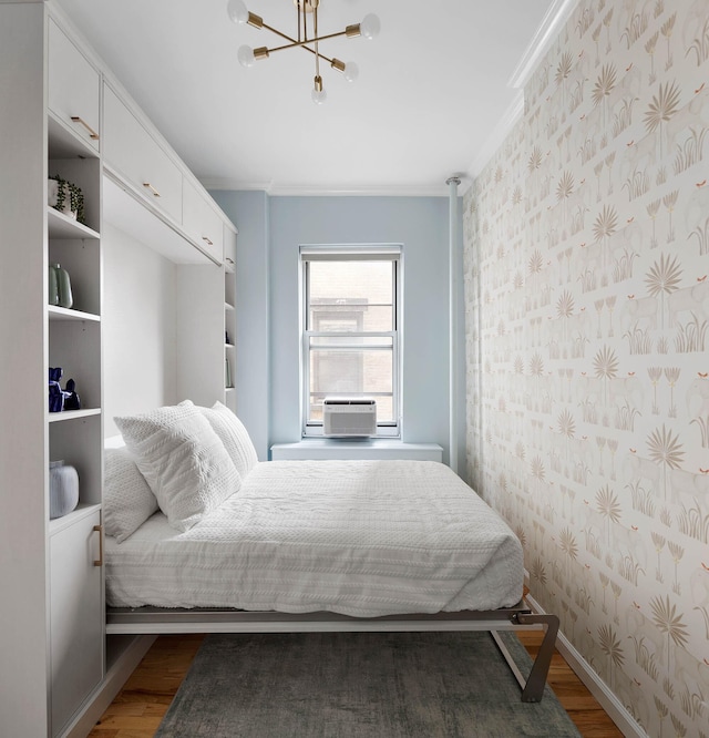 26 Gramercy Park S Unit 8Cd, New York City, NY 10003 - bedroom featuring wallpapered walls, wood finished floors, a chandelier, cooling unit, and crown molding