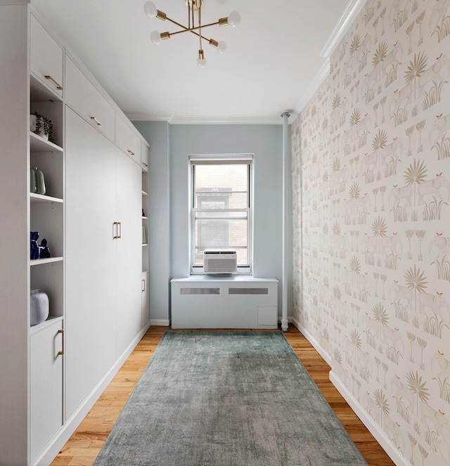 26 Gramercy Park S Unit 8Cd, New York City, NY 10003 - hall featuring wallpapered walls, light wood-style flooring, a chandelier, crown molding, and radiator