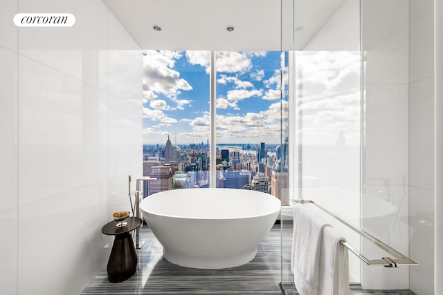 217 W 57th St Unit 82E, New York City, NY 10019 - bathroom featuring a freestanding bath and a view of city