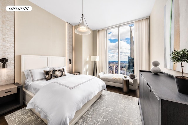 217 W 57th St Unit 82E, New York City, NY 10019 - bedroom with wood finished floors and expansive windows