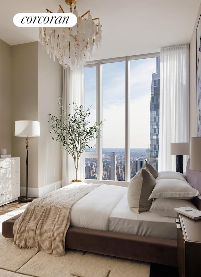 217 W 57th St Unit 82E, New York City, NY 10019 - bedroom featuring baseboards and wood finished floors
