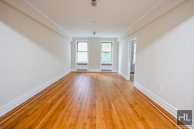 160 E 3rd St Unit 2F, New York City, NY 10009 - spare room with radiator heating unit and light wood finished floors
