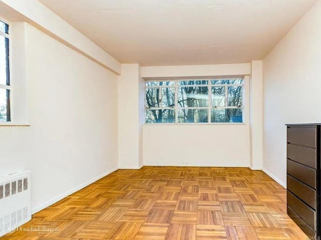 2727 Palisade Ave Unit 4L, New York City, NY 10463 - empty room with radiator heating unit and healthy amount of natural light