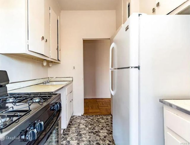 2727 Palisade Ave Unit 4L, New York City, NY 10463 - kitchen with freestanding refrigerator, gas stove, white cabinets, and light countertops