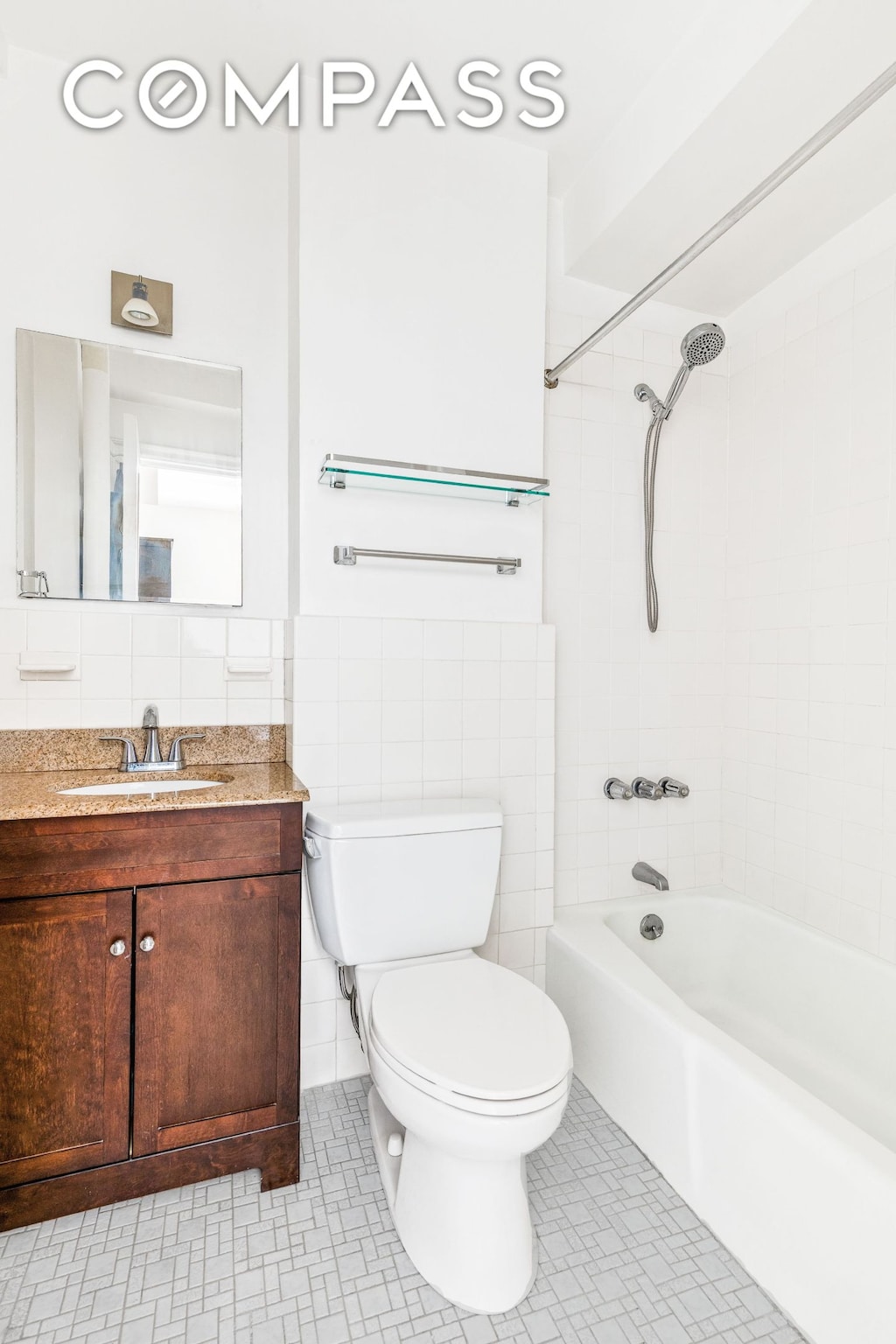 40 W 72nd St Unit 91A, New York City, NY 10023 - bathroom with vanity, tile walls,  shower combination, and a wainscoted wall