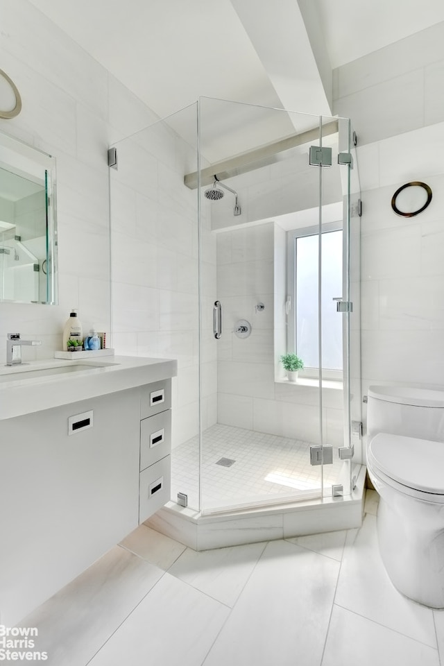 39 W 67th St Unit 1503, New York City, NY 10023 - bathroom with vanity, tile walls, tile patterned flooring, and a shower stall