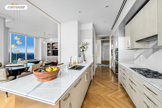 217 W 57th St Unit 84W, New York City, NY 10019 - kitchen with appliances with stainless steel finishes, a peninsula, modern cabinets, light stone countertops, and a wall of windows