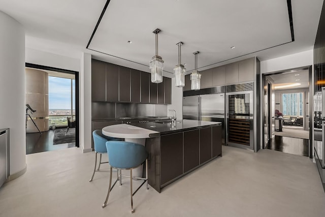 157 W 57th St Unit 64, New York City, NY 10019 - kitchen featuring modern cabinets, a kitchen breakfast bar, an island with sink, and healthy amount of natural light