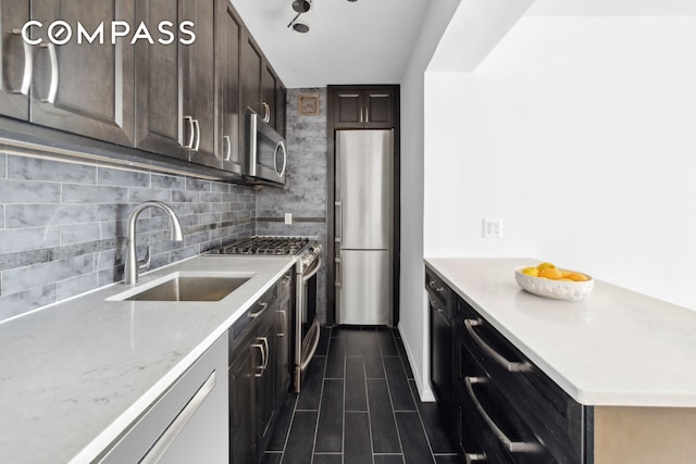 229 E 28th St Unit 6D, New York City, NY 10016 - kitchen with appliances with stainless steel finishes, decorative backsplash, dark brown cabinetry, light stone counters, and dark tile patterned flooring