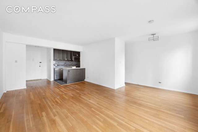 229 E 28th St Unit 6D, New York City, NY 10016 - unfurnished living room with light wood-type flooring and a sink
