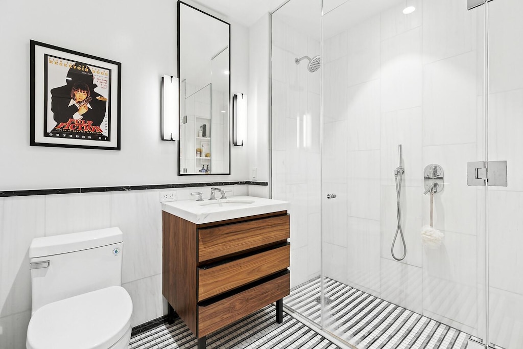 368 3rd Ave Unit 5E, New York City, NY 10016 - full bath featuring a stall shower, vanity, and tile patterned flooring