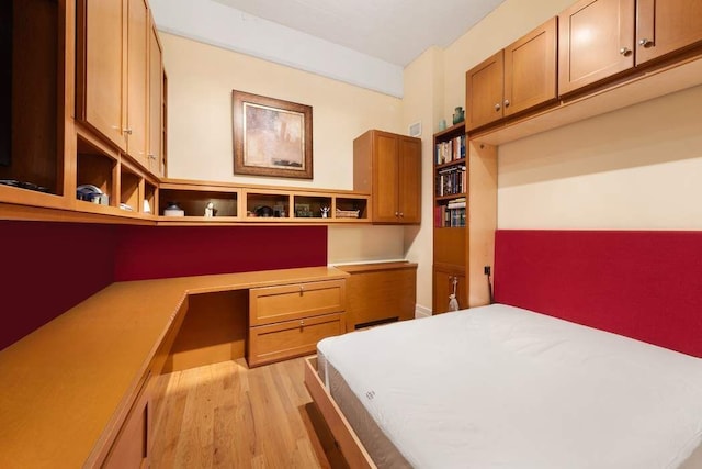 1 Main St Unit 10K, New York City, NY 11201 - bedroom featuring built in study area and light wood-style flooring