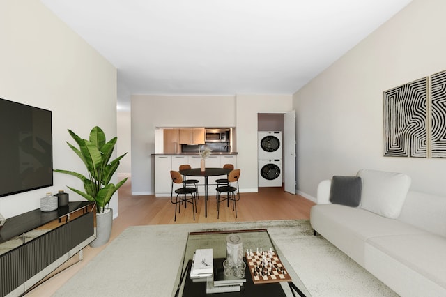 157 E 32nd St Unit 21B, New York City, NY 10016 - living room featuring stacked washer / drying machine and wood finished floors
