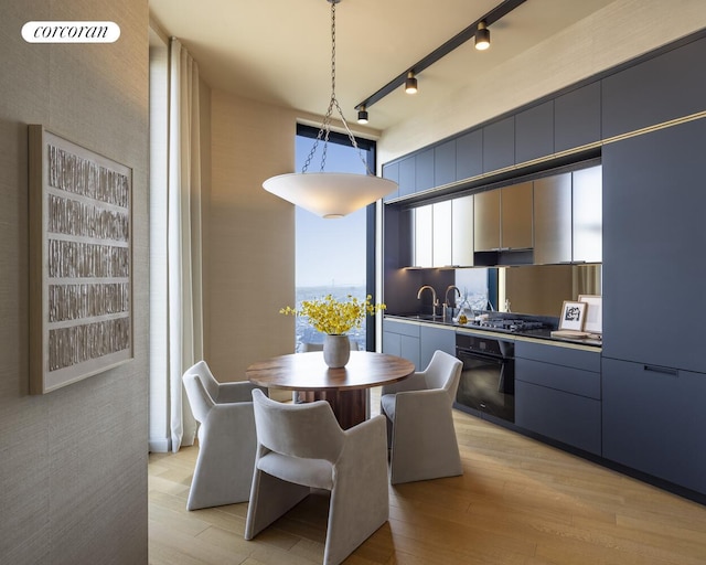 85 Fleet St Unit 73A, New York City, NY 11201 - dining room with light wood-style flooring and track lighting