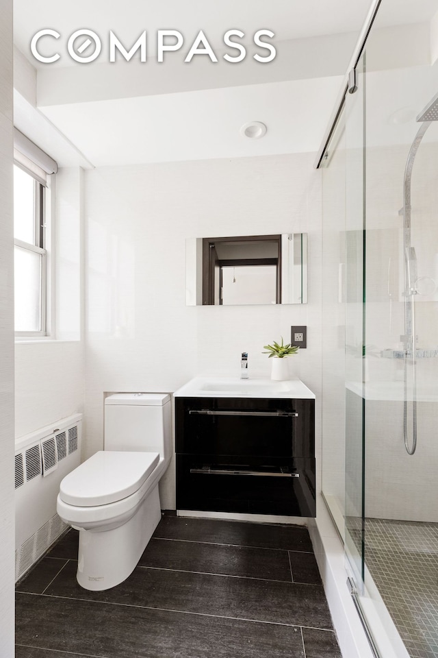 70 E 10th St Unit 3B, New York City, NY 10003 - full bathroom featuring radiator, vanity, and a stall shower