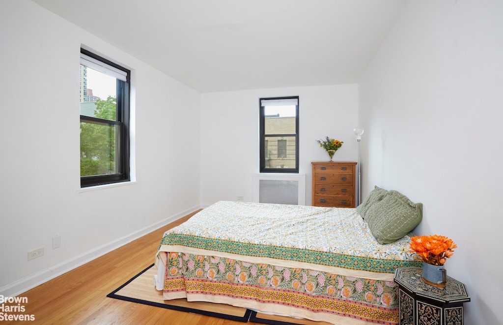 221 E 78th St Unit 6F, New York City, NY 10075 - bedroom with wood finished floors and baseboards