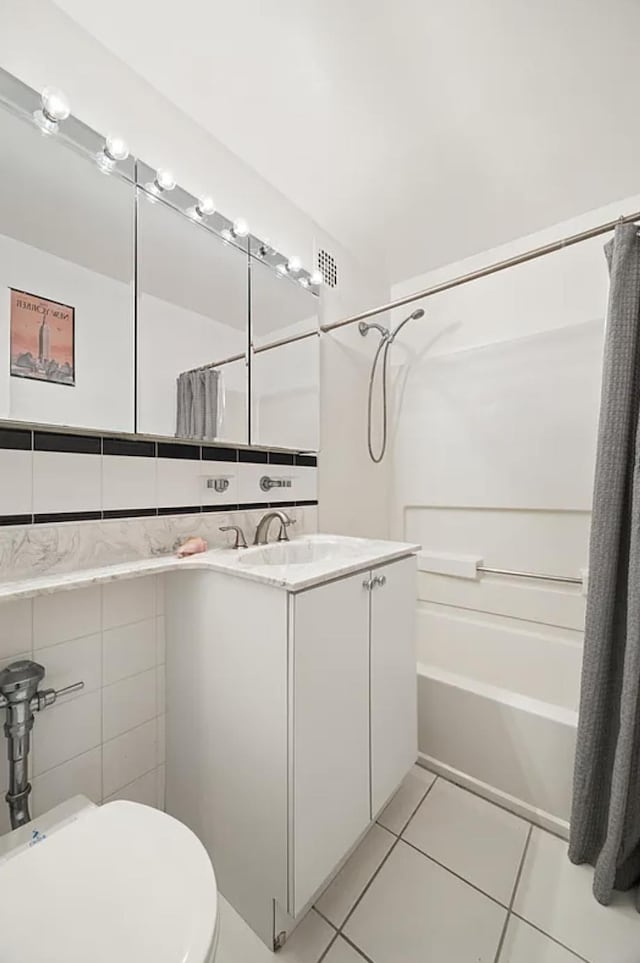 315 W 55th St Unit 1-D, New York City, NY 10019 - full bath with tile patterned flooring, shower / tub combo, vanity, and tile walls