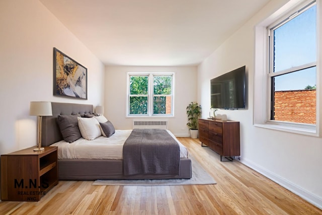 84-55 Daniels St Unit 3-H, New York City, NY 11435 - bedroom with radiator and wood finished floors