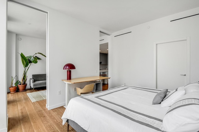 287 E Houston St Unit 4B, New York City, NY 10002 - bedroom with light wood-style flooring and baseboards