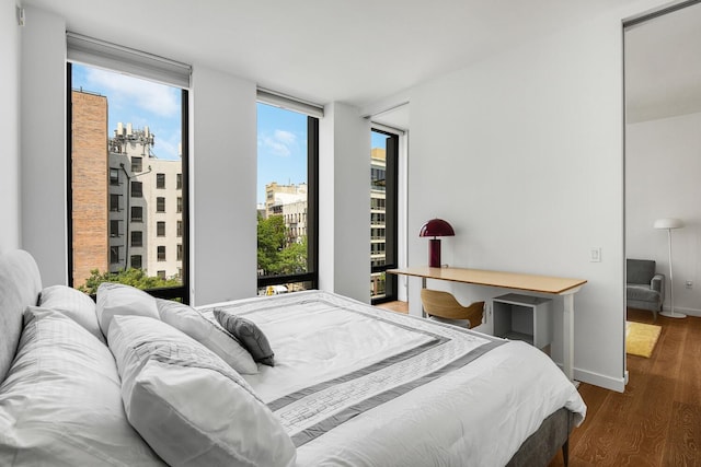 287 E Houston St Unit 4B, New York City, NY 10002 - bedroom with wood finished floors and baseboards