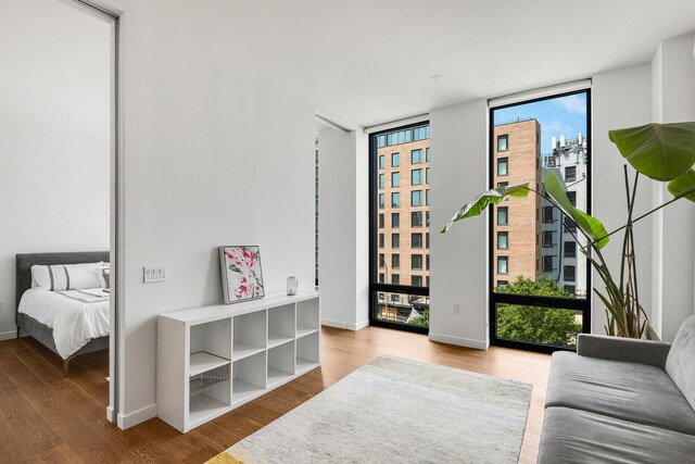 287 E Houston St Unit 4B, New York City, NY 10002 - bedroom with floor to ceiling windows and wood finished floors