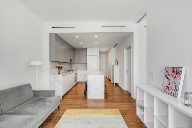 287 E Houston St Unit 4B, New York City, NY 10002 - living area featuring light wood-style flooring and recessed lighting