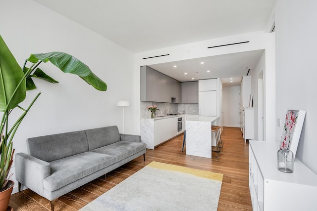 287 E Houston St Unit 4B, New York City, NY 10002 - living area featuring light wood-type flooring and recessed lighting
