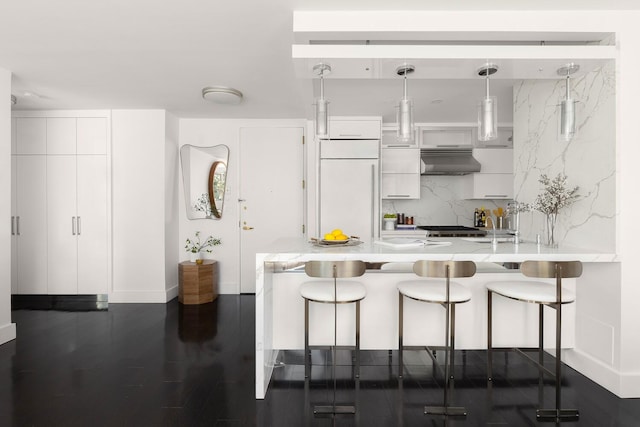 1965 Broadway Unit 8K, New York City, NY 10023 - kitchen with extractor fan, light countertops, a breakfast bar, and white cabinetry
