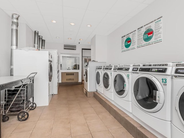 301 W 118th St Unit 7-H, New York City, NY 10026 - community laundry room with recessed lighting, separate washer and dryer, and light tile patterned floors