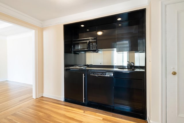 205 E 78th St Unit 14C, New York City, NY 10021 - kitchen with black appliances, dark cabinetry, light wood-style floors, dark countertops, and modern cabinets